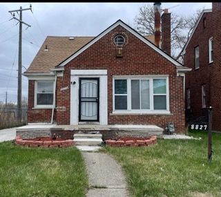 bungalow-style home featuring brick siding, a chimney, and a front lawn
