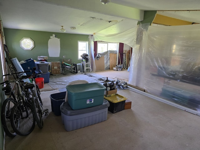 misc room featuring beam ceiling and a wealth of natural light
