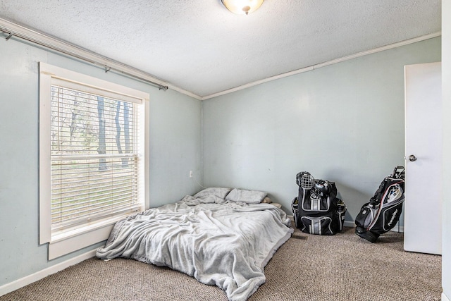 carpeted bedroom featuring baseboards, ornamental molding, and a textured ceiling