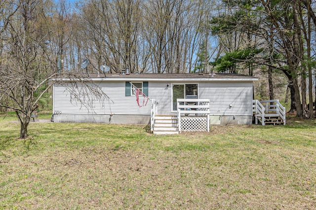 manufactured / mobile home with a front yard, a deck, and crawl space