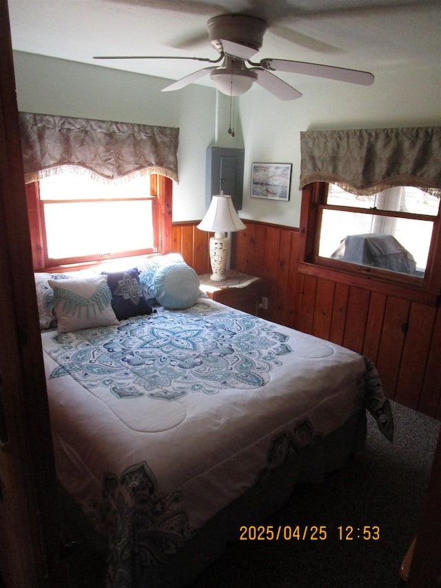 975 N Huron, East Tawas, MI 48730 - bedroom featuring a wainscoted wall, wooden walls, and ceiling fan
