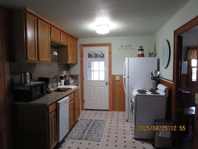 975 N Huron, East Tawas, MI 48730 - kitchen featuring a wealth of natural light, white appliances, wainscoting, and a sink