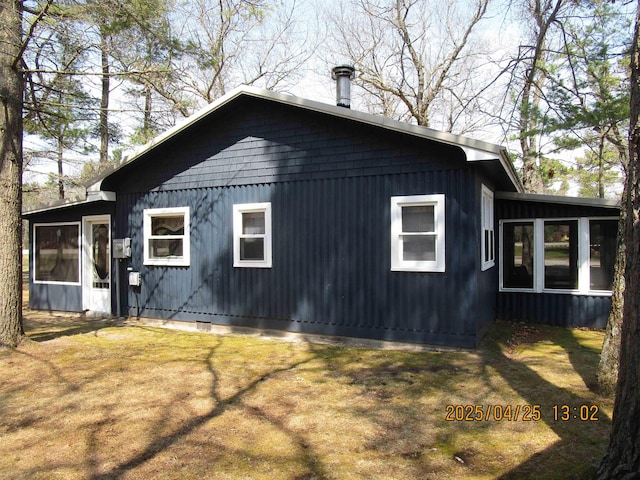 975 N Huron, East Tawas, MI 48730 - view of home's exterior featuring a lawn and a sunroom