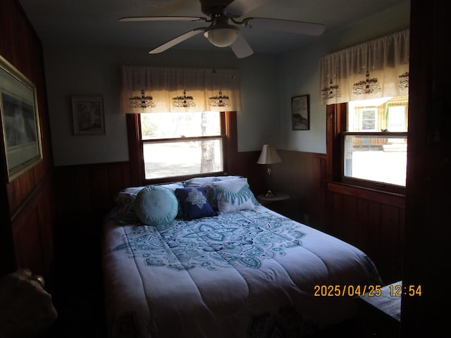 975 N Huron, East Tawas, MI 48730 - bedroom with a wainscoted wall and ceiling fan