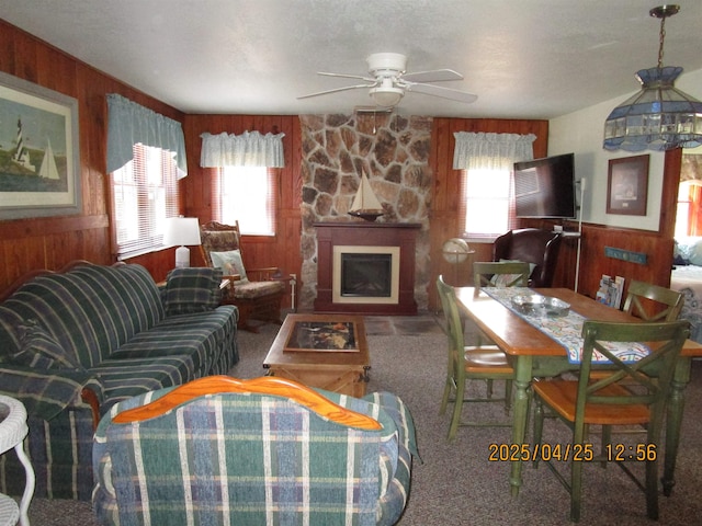 975 N Huron, East Tawas, MI 48730 - carpeted living area with a wealth of natural light, wood walls, and ceiling fan