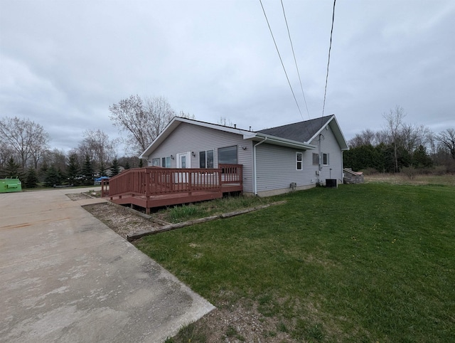3344 E Huron, Au Gres, MI 48703 - view of side of property featuring central air condition unit, a deck, and a lawn