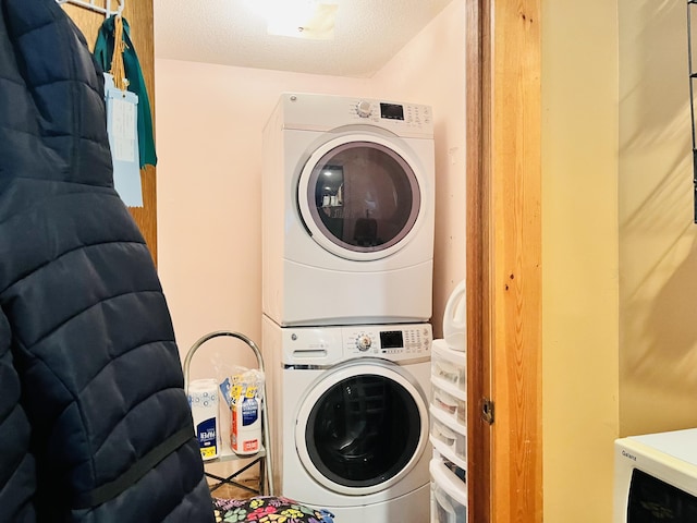 clothes washing area featuring laundry area and stacked washer and dryer