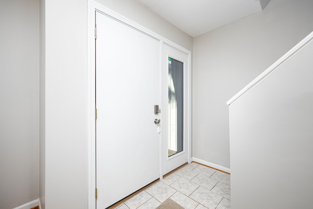 568 Foxboro Sq Unit 59, Brighton, MI 48116 - foyer with baseboards and light tile patterned floors