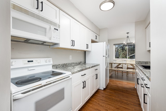 568 Foxboro Sq Unit 59, Brighton, MI 48116 - kitchen with pendant lighting, white appliances, white cabinetry, a chandelier, and dark wood finished floors
