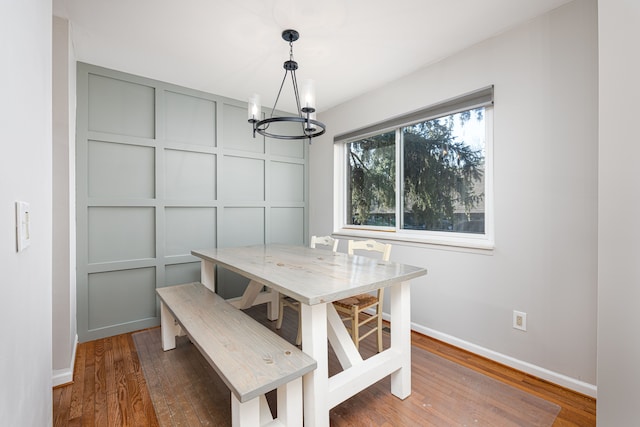 568 Foxboro Sq Unit 59, Brighton, MI 48116 - dining area with baseboards, wood finished floors, and a chandelier