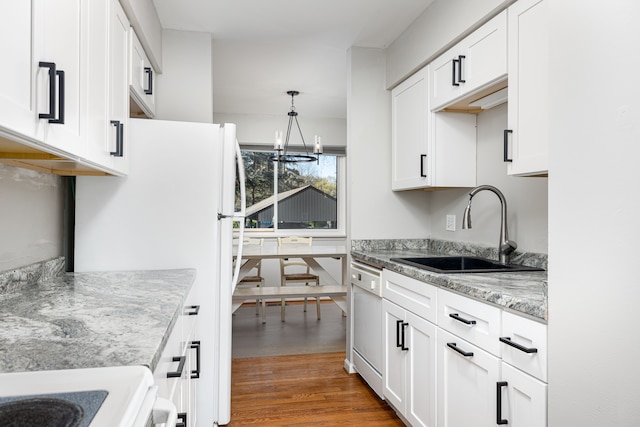 568 Foxboro Sq Unit 59, Brighton, MI 48116 - kitchen featuring white cabinets, white dishwasher, a notable chandelier, a sink, and wood finished floors