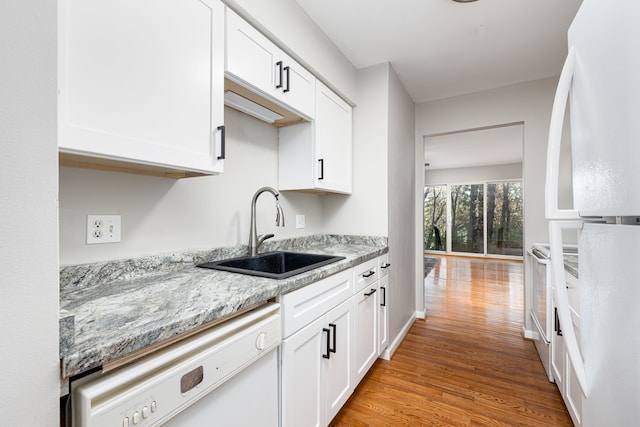 568 Foxboro Sq Unit 59, Brighton, MI 48116 - kitchen with light stone counters, a sink, white appliances, white cabinetry, and wood finished floors