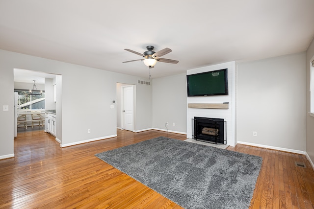568 Foxboro Sq Unit 59, Brighton, MI 48116 - unfurnished living room with a ceiling fan, baseboards, visible vents, and wood finished floors