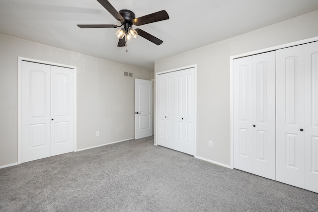 568 Foxboro Sq Unit 59, Brighton, MI 48116 - unfurnished bedroom with ceiling fan, carpet, two closets, baseboards, and visible vents