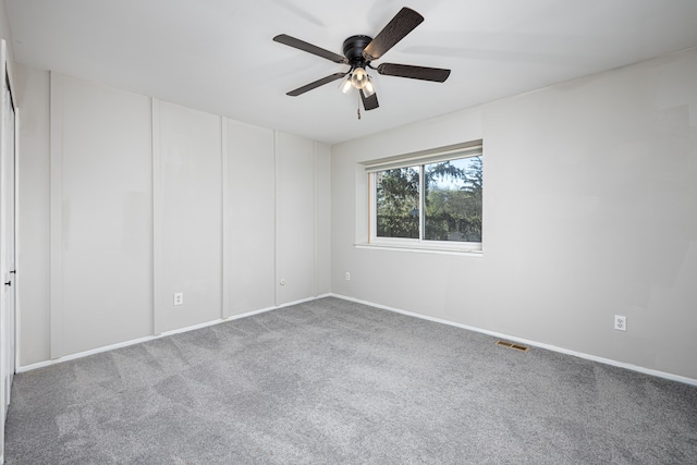 568 Foxboro Sq Unit 59, Brighton, MI 48116 - carpeted empty room with visible vents, a ceiling fan, and baseboards