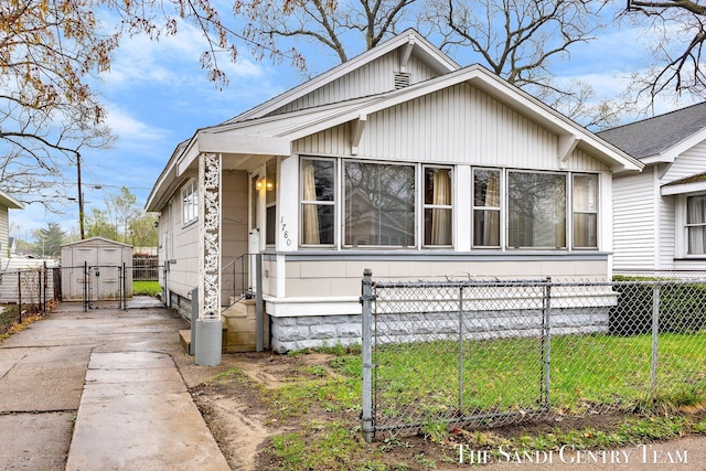 bungalow featuring driveway, fence, and a gate