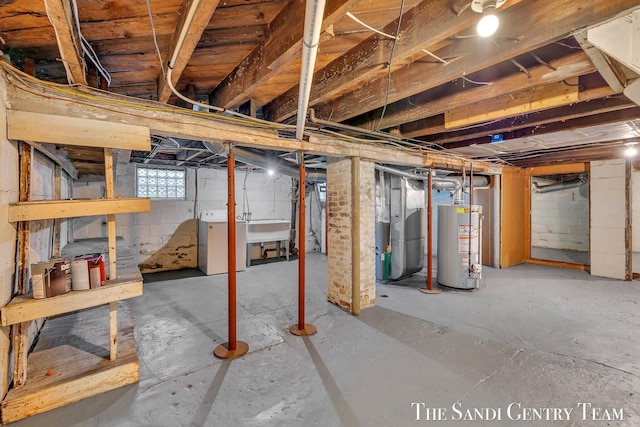 basement with a sink, washer / clothes dryer, heating unit, and water heater