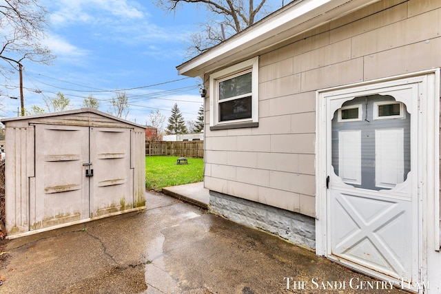 view of shed featuring fence