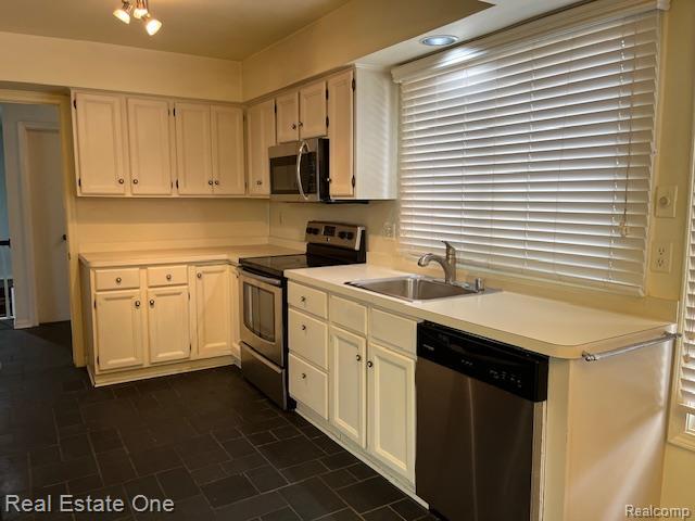 1797 Golf Ridge Dr, Bloomfield Hills, MI 48302 - kitchen with stainless steel appliances, light countertops, and white cabinetry