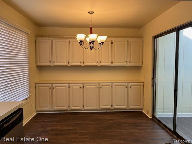1797 Golf Ridge Dr, Bloomfield Hills, MI 48302 - unfurnished dining area featuring a chandelier, dark wood-type flooring, and plenty of natural light