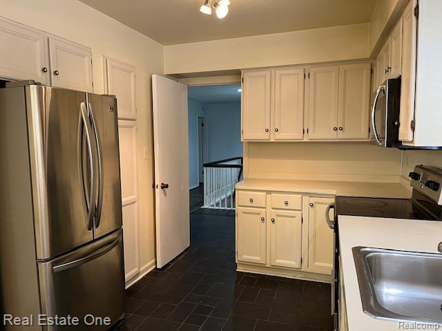 1797 Golf Ridge Dr, Bloomfield Hills, MI 48302 - kitchen featuring stainless steel appliances, light countertops, and white cabinetry