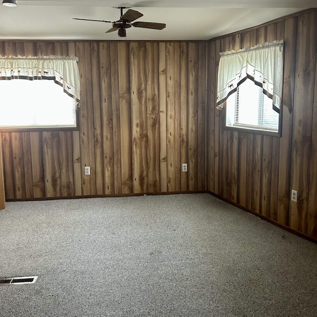 4910 W Saginaw, Vassar, MI 48768 - carpeted spare room with wooden walls, a ceiling fan, and visible vents