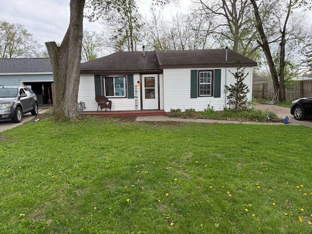 ranch-style home with a porch, a front lawn, and fence