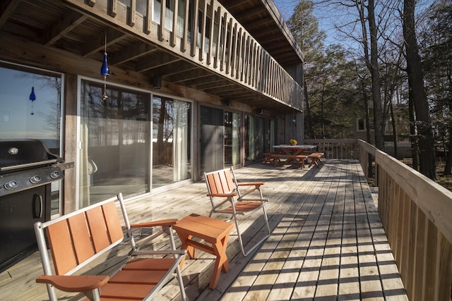 wooden deck featuring outdoor dining area