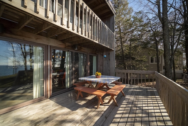 wooden terrace with outdoor dining area