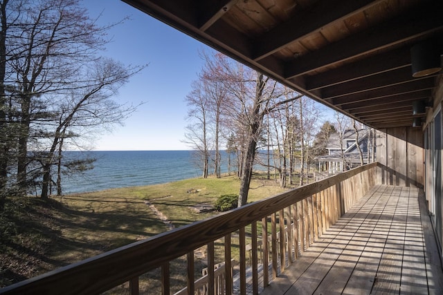wooden terrace featuring a water view