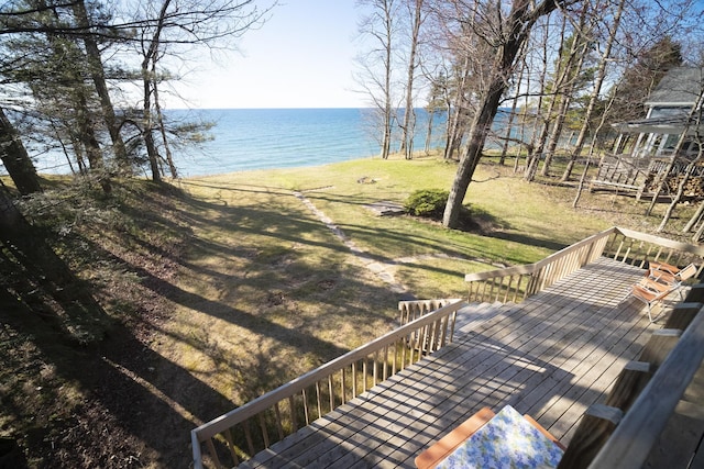 deck with a lawn and a water view
