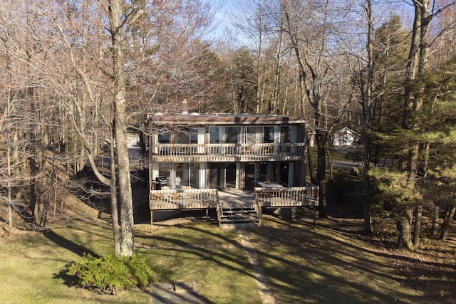 back of property featuring a yard and a deck