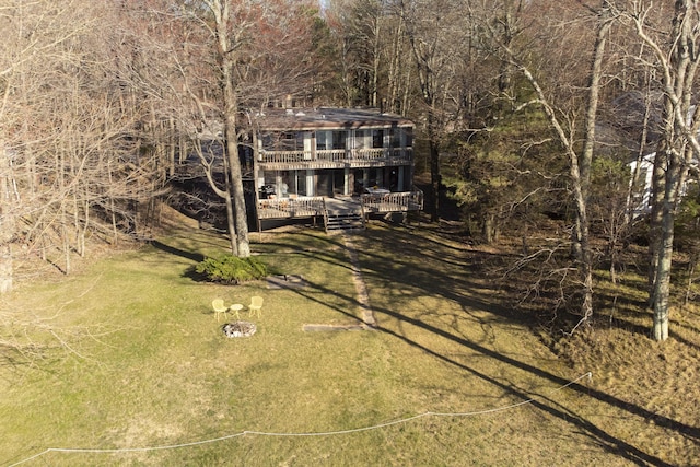 colonial inspired home with a front yard, a balcony, and a deck