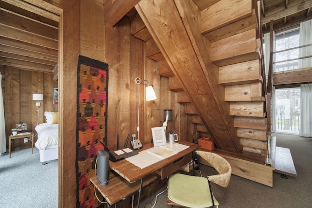carpeted office space featuring wood walls and plenty of natural light