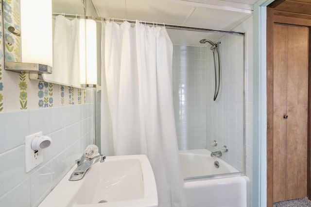 full bath with a sink and shower / tub combo with curtain