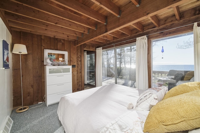 bedroom with visible vents, wood walls, dark carpet, access to outside, and wooden ceiling