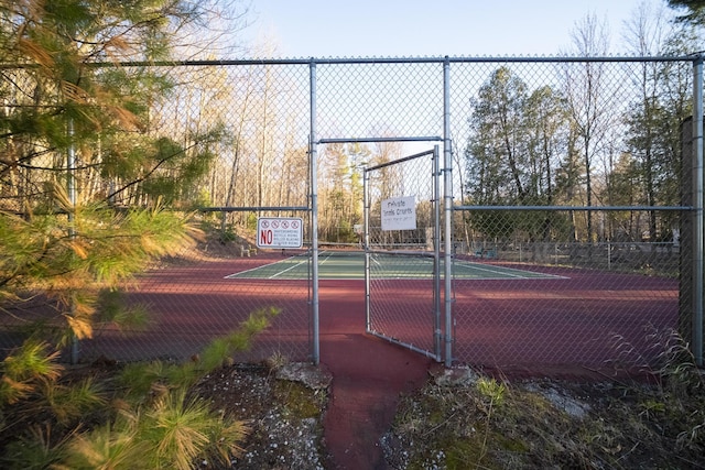 view of tennis court featuring fence
