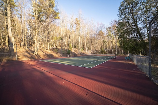 view of sport court featuring fence