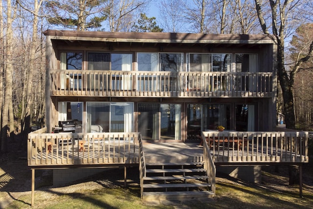 back of property featuring a wooden deck