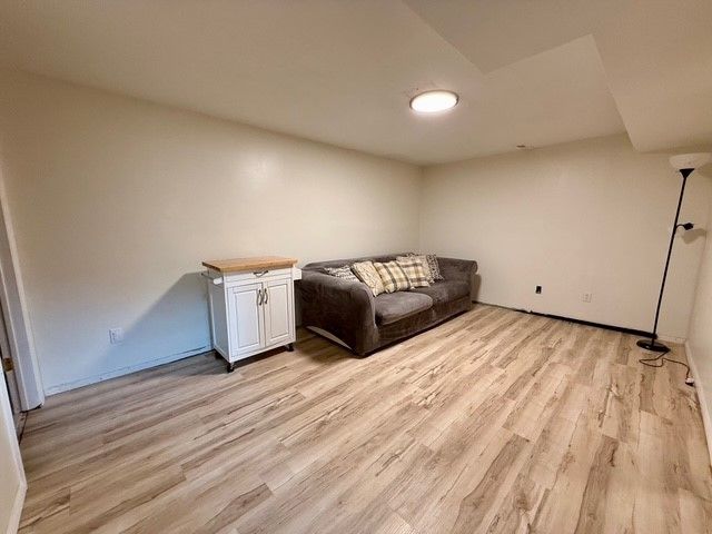 living area with light wood-style floors and baseboards
