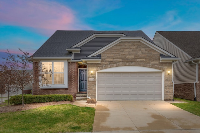 2774 Polson St, Ann Arbor, MI 48105 - view of front of property with a front yard, driveway, stone siding, and a garage