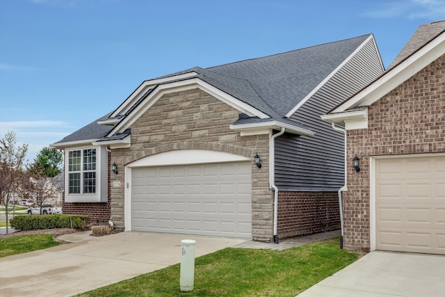 2774 Polson St, Ann Arbor, MI 48105 - view of front of house featuring brick siding, concrete driveway, an attached garage, a shingled roof, and stone siding