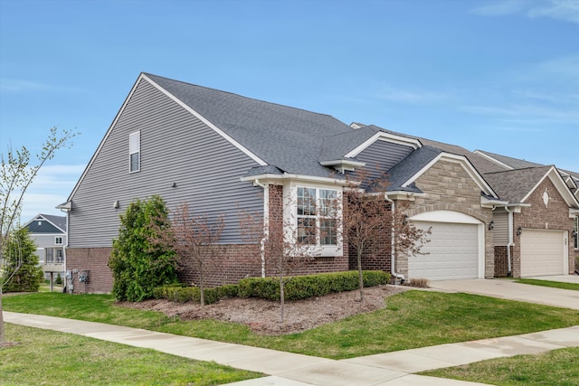 2774 Polson St, Ann Arbor, MI 48105 - view of front facade featuring brick siding, driveway, a front yard, and a garage