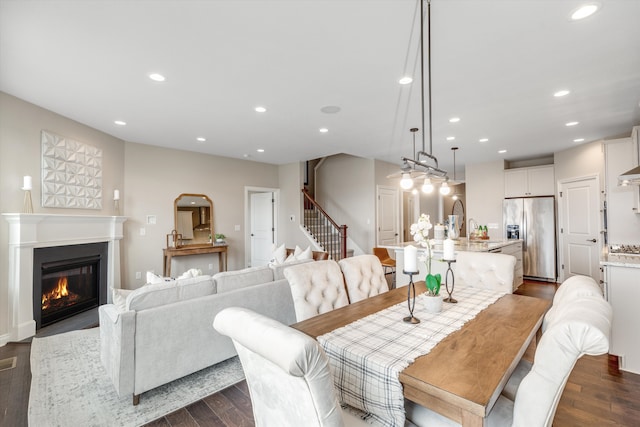 2774 Polson St, Ann Arbor, MI 48105 - dining area with stairs, recessed lighting, dark wood finished floors, and a glass covered fireplace