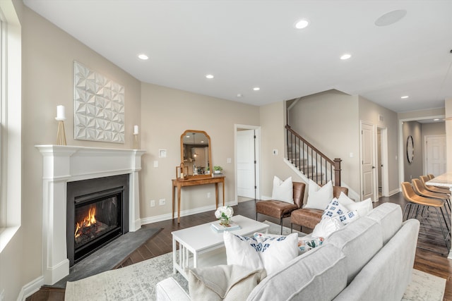 2774 Polson St, Ann Arbor, MI 48105 - living area featuring dark wood finished floors, stairs, baseboards, a glass covered fireplace, and recessed lighting