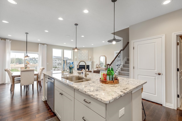 2774 Polson St, Ann Arbor, MI 48105 - kitchen featuring a sink, a fireplace, dark wood finished floors, an island with sink, and stainless steel dishwasher