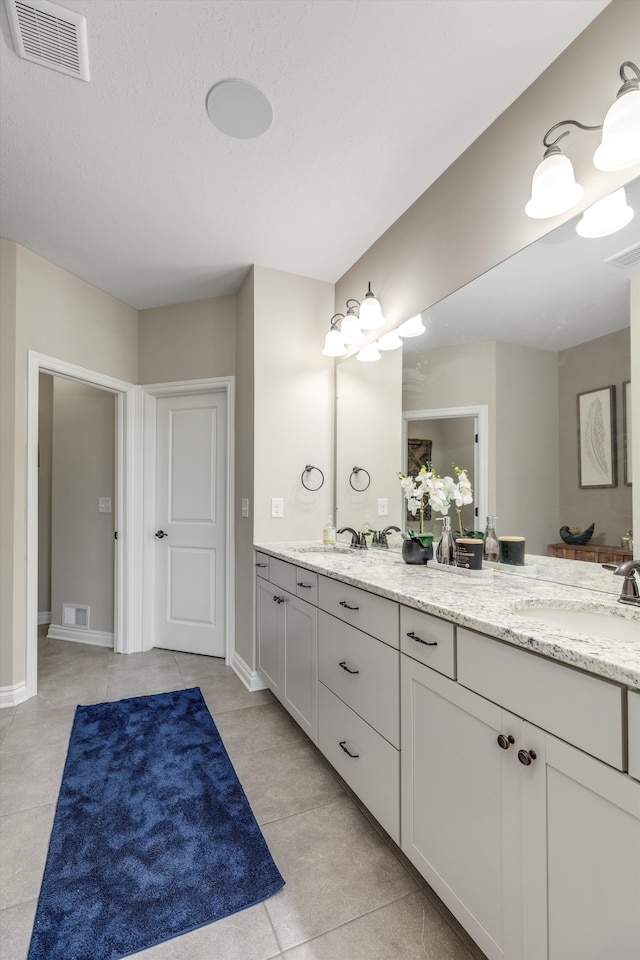2774 Polson St, Ann Arbor, MI 48105 - bathroom featuring visible vents, double vanity, and tile patterned flooring