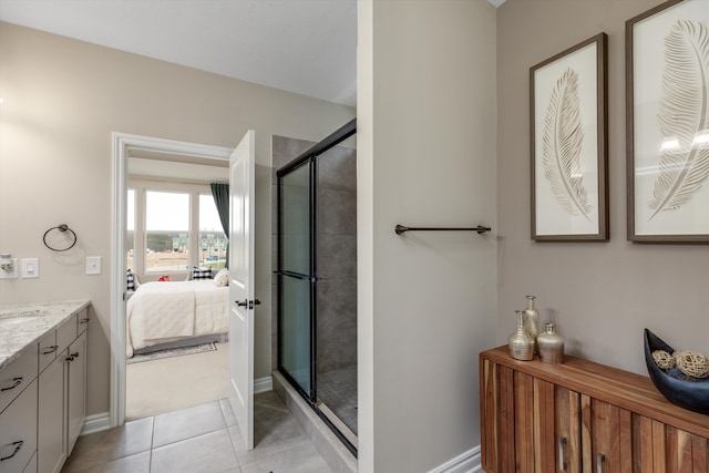2774 Polson St, Ann Arbor, MI 48105 - bathroom with tile patterned flooring, a stall shower, vanity, baseboards, and ensuite bath