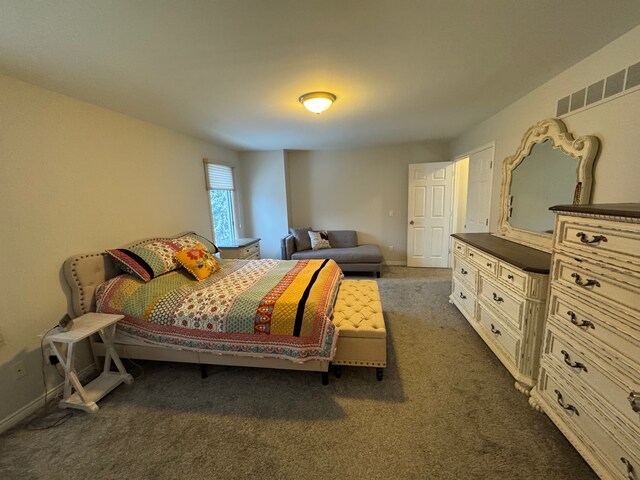 bedroom featuring baseboards, carpet flooring, and visible vents
