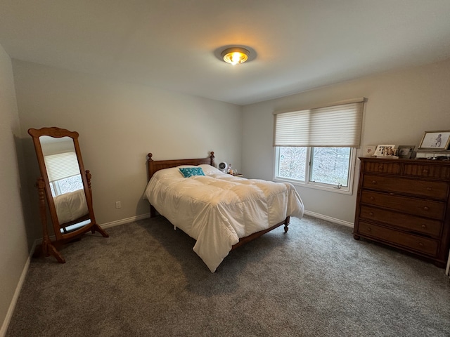 bedroom featuring baseboards and carpet flooring